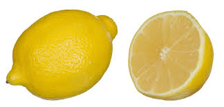 A whole lemon with a half lemon to its right