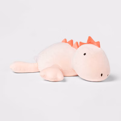 A light pink dinosaur stuffed animal that is weighted.