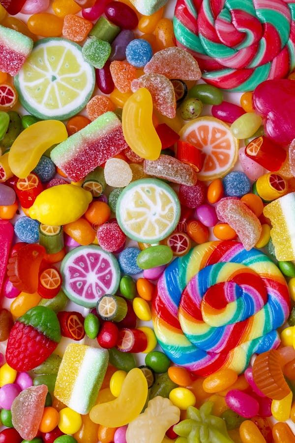 Multiple pieces of rainbow colored sour candy in different shapes